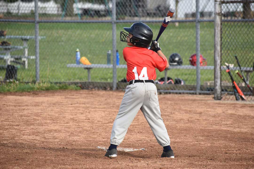 8 years old boy playing baseball