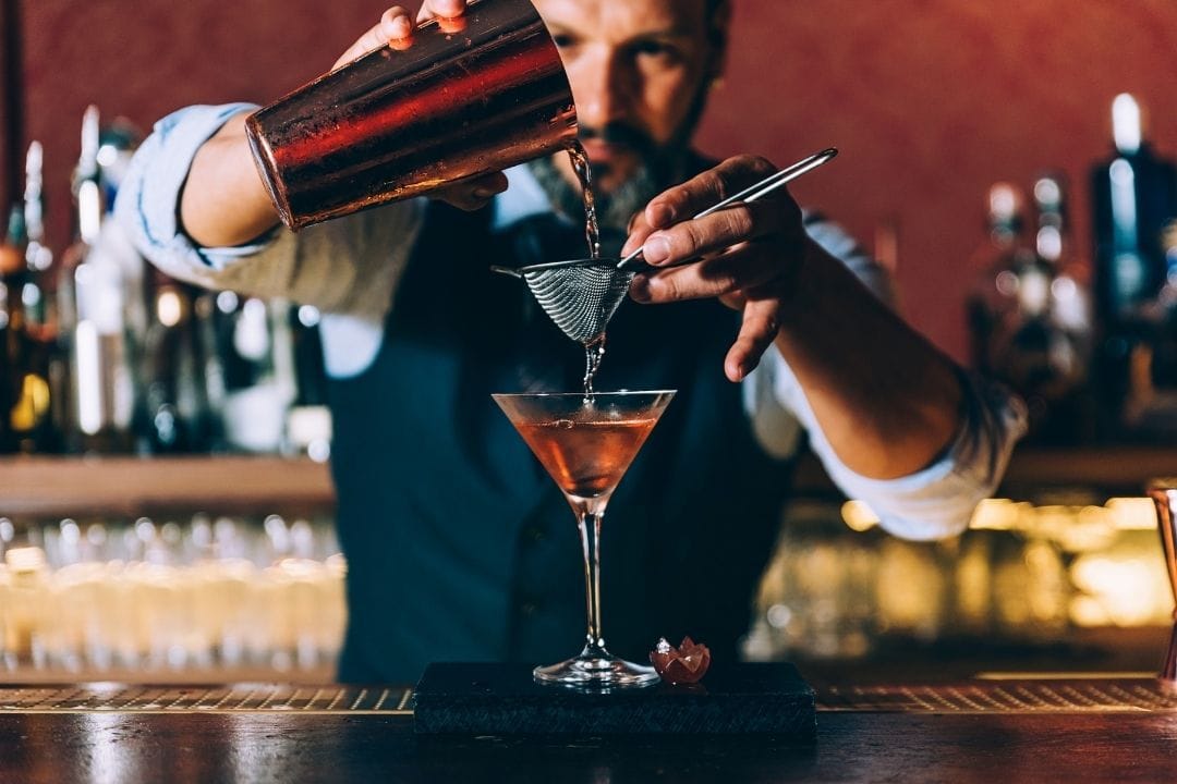 BARTENDER pouring a cocktail