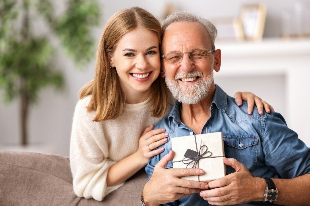 woman giving her boyfriend's father a presen