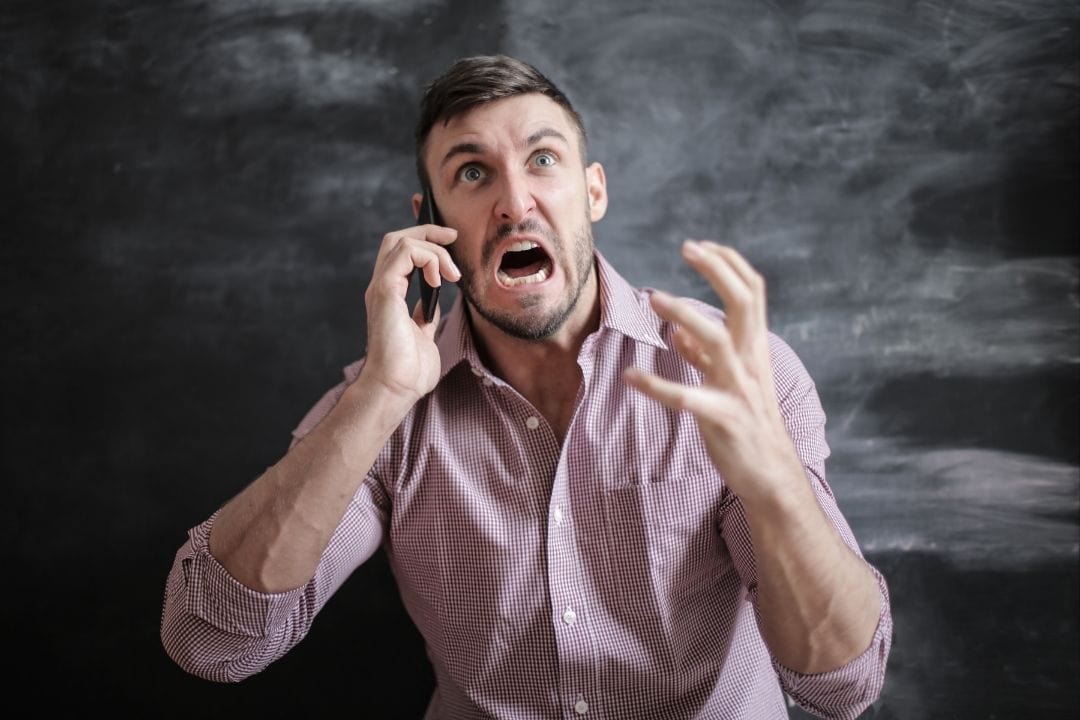 anxious angry guy on the phone