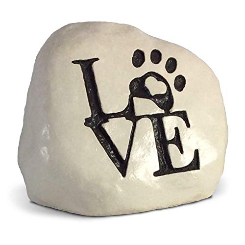 stone with a paw on it and written the word love