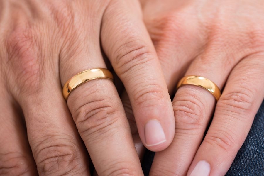 parents hands with wedding rings