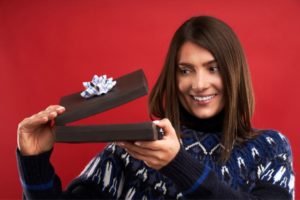 thirty year old woman opening a present